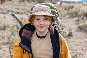 At teenage boy smiles for the camera while hiking to at ThreePeaks Ascent, a short-term Residential treatment center for Teens