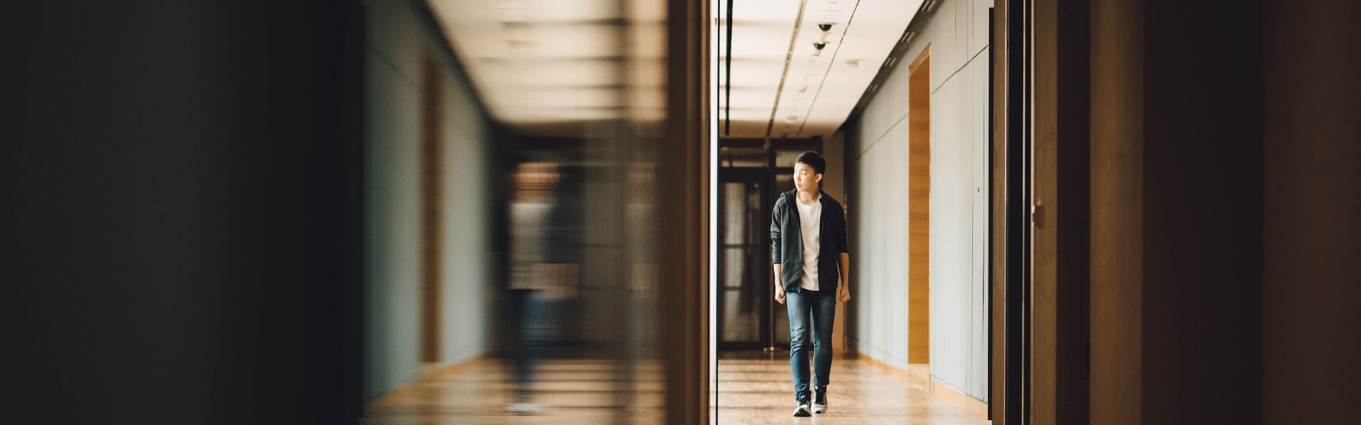 A teen walking down a hall | a photo illustrating an article on the importance of teen identity development and formation | ThreePeaks Residential Treatment Center for Teens