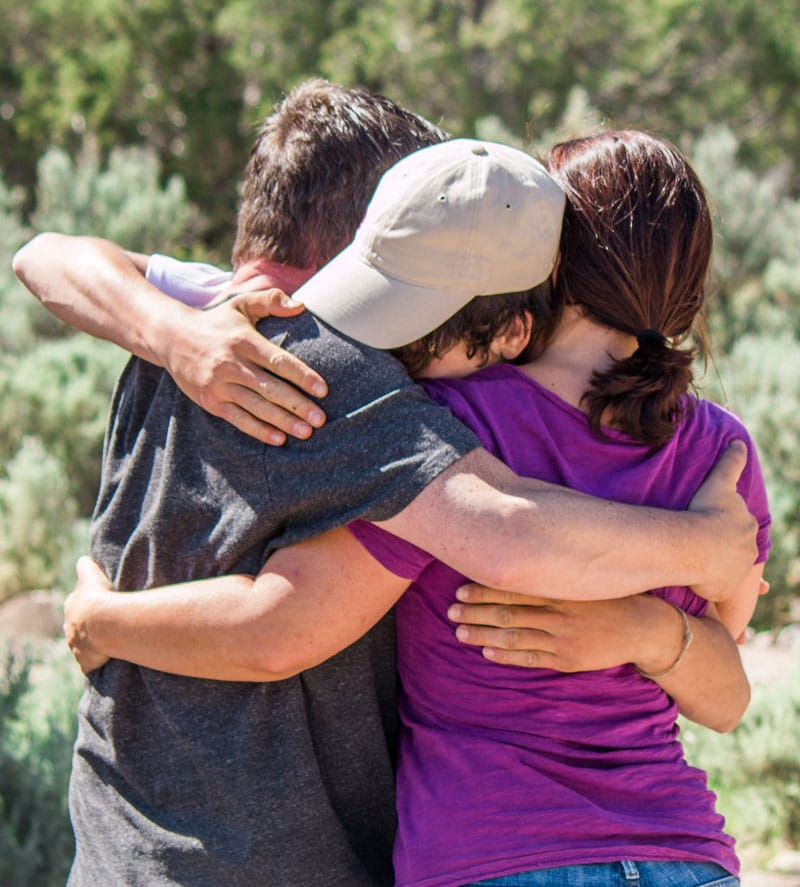 the-Power-of-Nature-Therapy-parent-hug-at-graduation-Healing-ThreePeaks-Ascent