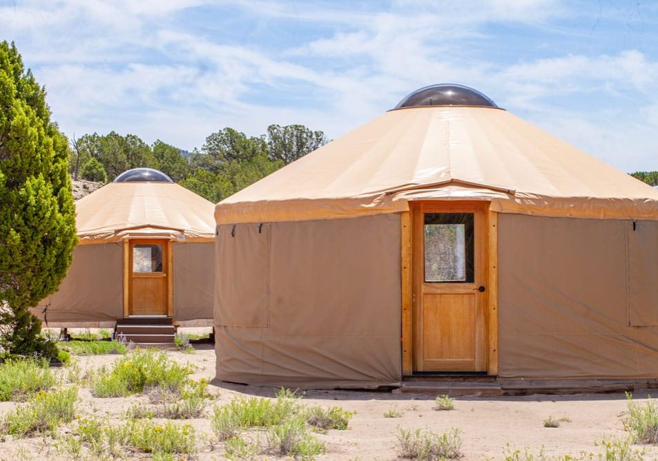 yurts-at-the-field-with-low-desert-grasses-at-threepeaks-ascent